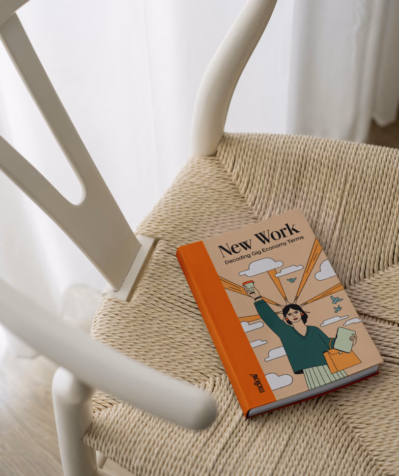 The New Work book lying on a woven chair seat