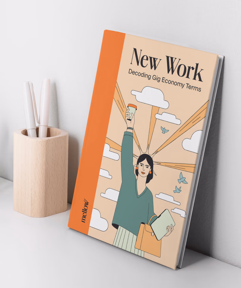 The New Work book standing on a desk next to a pencil holder